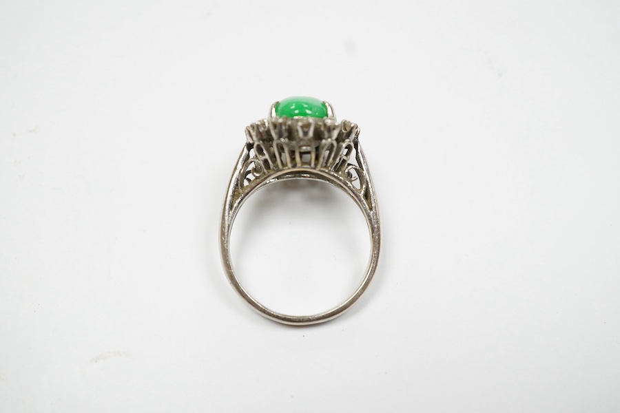 A white metal, jade and diamond set oval cluster ring, size N, gross weight 5.4 grams. Condition - fair to good